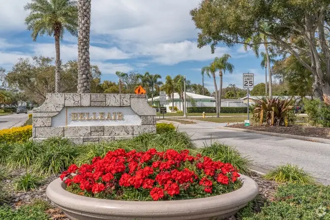 Belleair neighborhood entrance sign with palm trees and vibrant flowerbeds, Tampa Bay Home Services cleaning